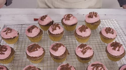 Drizzling Chocolate Ganache on Top of Bake Chocolate Raspberry Cupcakes