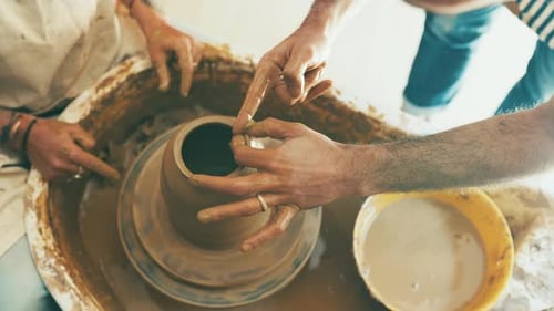 Potters Creating Clay Vase on Wheel Overhead Shot