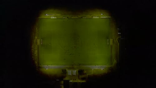 Top down view of football players during practice match in night time setting.