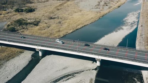 Vehicles Travelling At Mutsumi Bridge Over Tama River With Itsukaichi Line Bridge In The Background