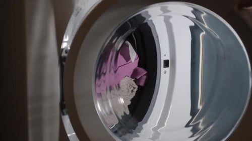 Hand opening washing door to unload washing