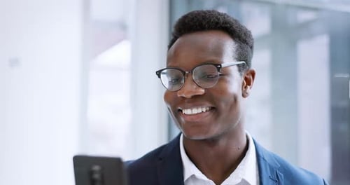 Young Adult Smiles at Phone in Office Environment