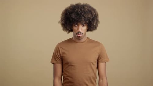 Man with Afro Hairstyle Staring at the Camera