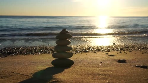 Balanced Rock Pyramid on Pebbles Beach Sunny Day and Clear Sky at Sunset