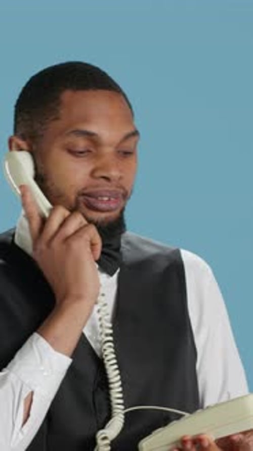 Smiling Man Answering Call on Vintage Rotary Phone