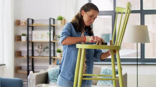 Woman Sands Wooden Chair in Bright Living Room