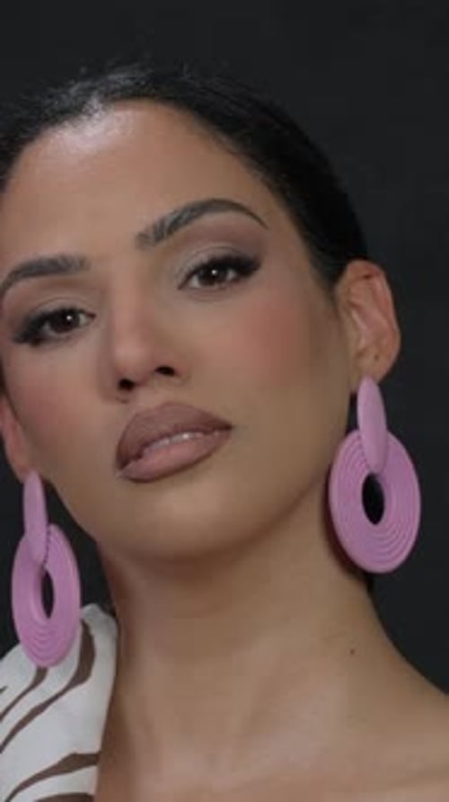 Woman Modeling with Stylish Makeup and Large Earrings
