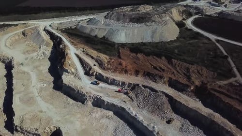 Excavator Loads Ore Into a Large Mining Dump Truck Open Pit
