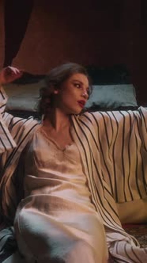 Relaxed and Serene, Pale-Skinned Vampire Woman Reclining on Bed