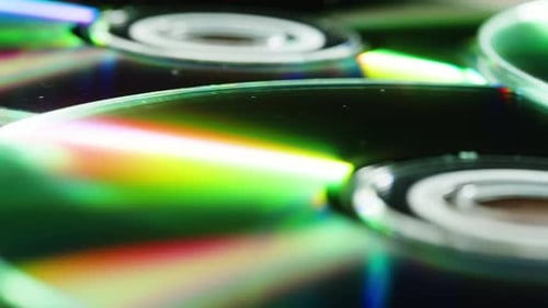 CD Disks on Black Background Closeup Old Vintage Disks for DVD Player or Computer Music Recorder