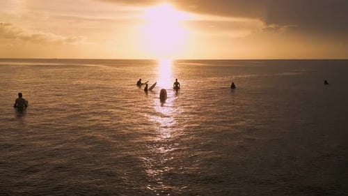 Calm Twilight Scene With Surfers Peacefully Reclining On Surfboards