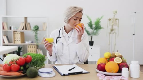 Nutritionist Doctor with Fresh Fruit and Orange Juice