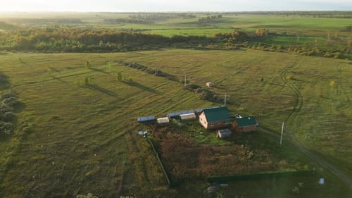 Aerial View of Rural House and Farm During Beautiful Autumn Sunset Sprawling Farmland