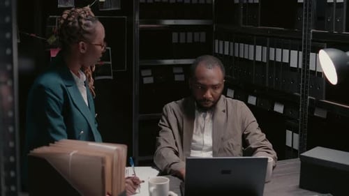 Investigators Discussing Case in Dark Office Setting