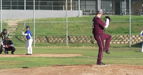 Baseball Pitcher on the Mound Throwing the Ball