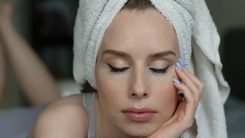 Woman with Towel on Head Lying on Bed