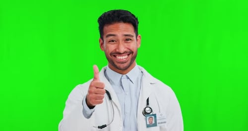 Thumbs up, success and doctor on green screen for healthcare, excellence in hospital