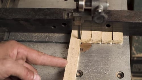 Close shot of a machine that is cutting wood in a square shapes