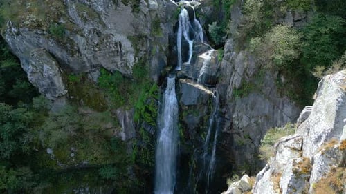 Aerial View of Famous Fervenza do Toxa (Toxa Waterfall) Flowing Through Mountain Cliffs