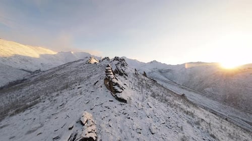 Snowy Mountains at Sunrise: Aerial Winter Landscape