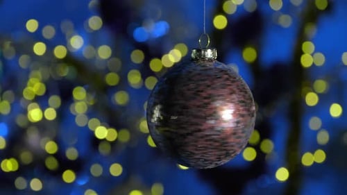 Shiny Christmas Ornament Spinning with Blue Background