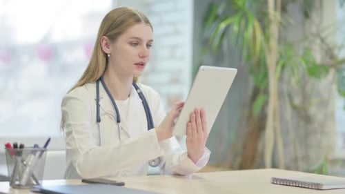 Doctor Browsing Tablet in Clinic