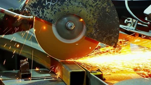 Worker Using an Angle Grinder Producing a Lot of Sparks