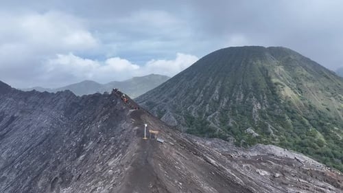 aerial view flying to mount Bromo active volcano above sea of clouds, Java, Indonesia