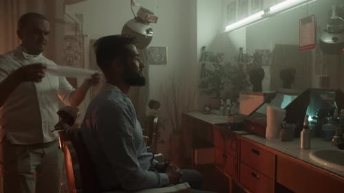 Barber Prepares Male Client with Beard for Shaving in Barbershop