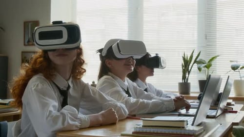 Students Using VR Headsets and Laptops in Class