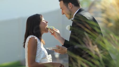 Bride and Groom Sharing Cake at Wedding Ceremony