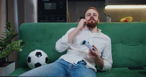 Man Relaxing on Couch Playing Video Game