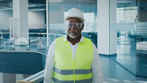 Mature African American Businessman in Office Wearing Safety Gear and Glasses