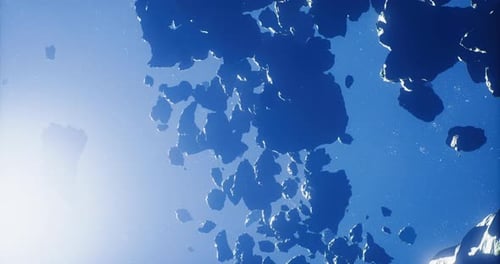 Mysterious Rocky Formations Floating in Deep Blue Space During Sunlight