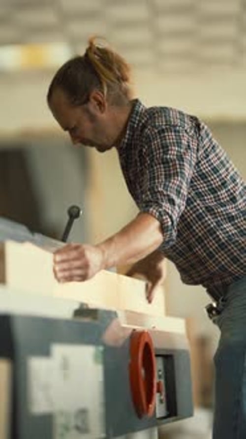Skilled Carpenter Planing Wooden Beam in Workshop