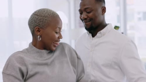 Cheerful Couple Dancing and Laughing in Modern Apartment