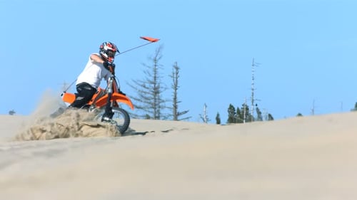 Man Riding a Motorcycle in Sand,