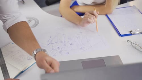 Architects Collaborate on Project in Modern Office