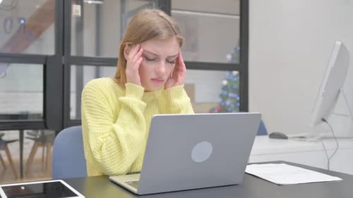 Stressed Woman Working on Laptop in Office