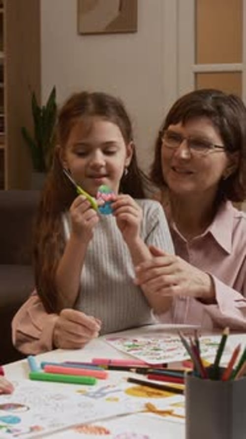 Vertical of Grandma Enjoying Creative Activity with Beloved Granddaughter
