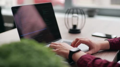 Close Up of Freelancer's Hands Typing Code on Laptop Keyboard Camera Slides Around Developer's
