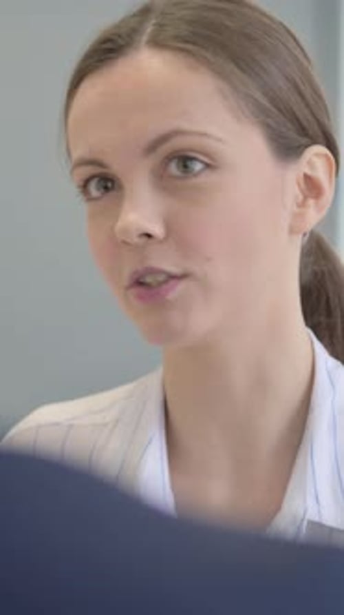 Close Up of Mixed Race Teammates Talking at Work, vertical video