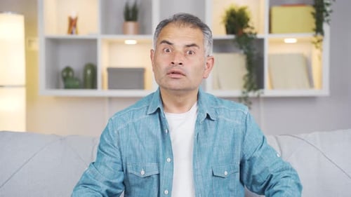 Man Talking and Showing Confused Expressions Indoors