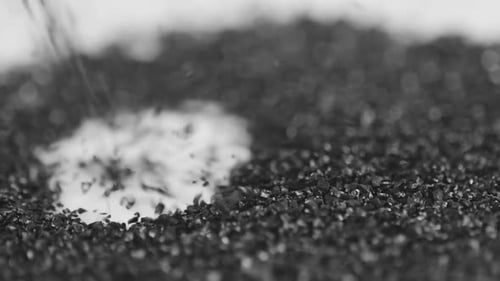 Granular Black Material Filling into a Pile