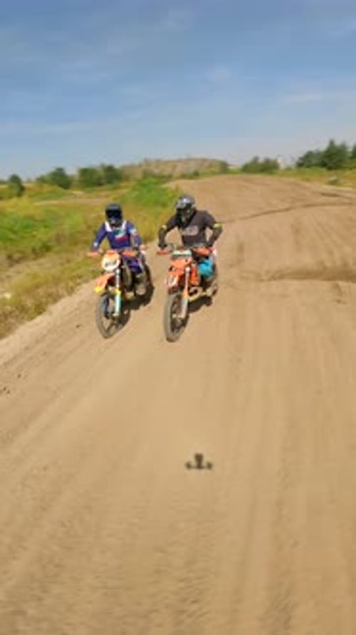 Dirt Bikes Riding on Sandy Track