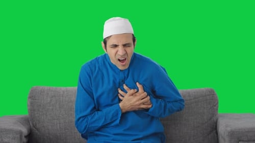 Sick Muslim man having severe heart attack Green screen