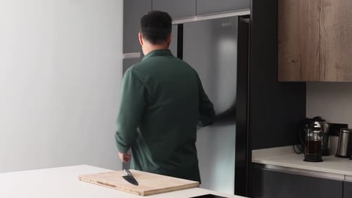 Man Prepares Vegetables at Kitchen Island Counter