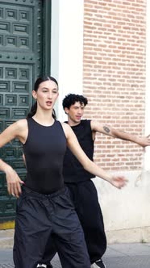 Talented Dancers Performing Synchronized Choreography on a City Street