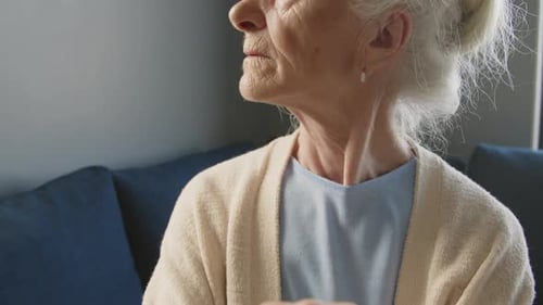 Senior Woman Holding Cane at Home