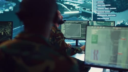 Two Men in Camouflage at Computer Workstations